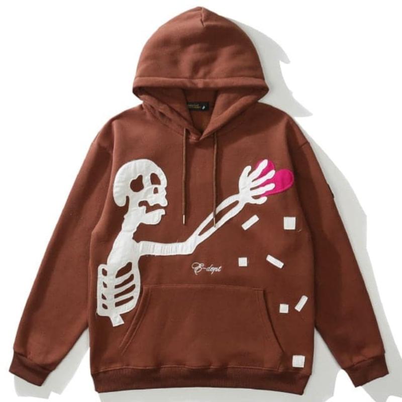 Icy Minded. A cozy brown hoodie featuring a playful skeleton holding a heart, perfect for adding a quirky touch to your outfit.