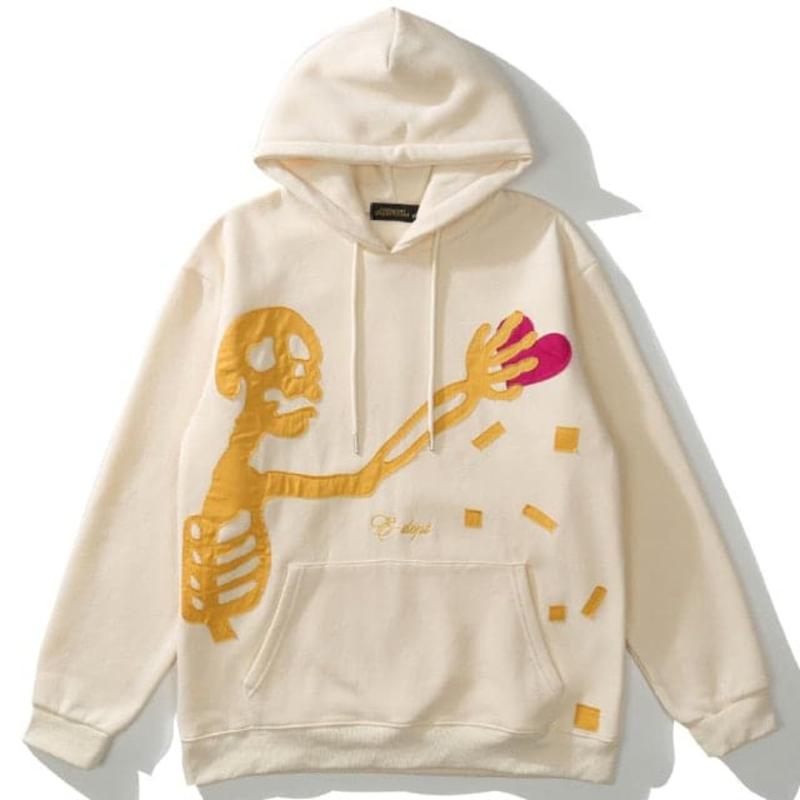 Icy Minded. A trendy beige hoodie with a skeleton design holding a heart, ideal for those who love a mix of comfort and creativity.